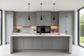 15-cabinet modern kitchen fully installed with gray flat-front cabinets, matte black hardware, waterfall quartz island, and pendant lighting
